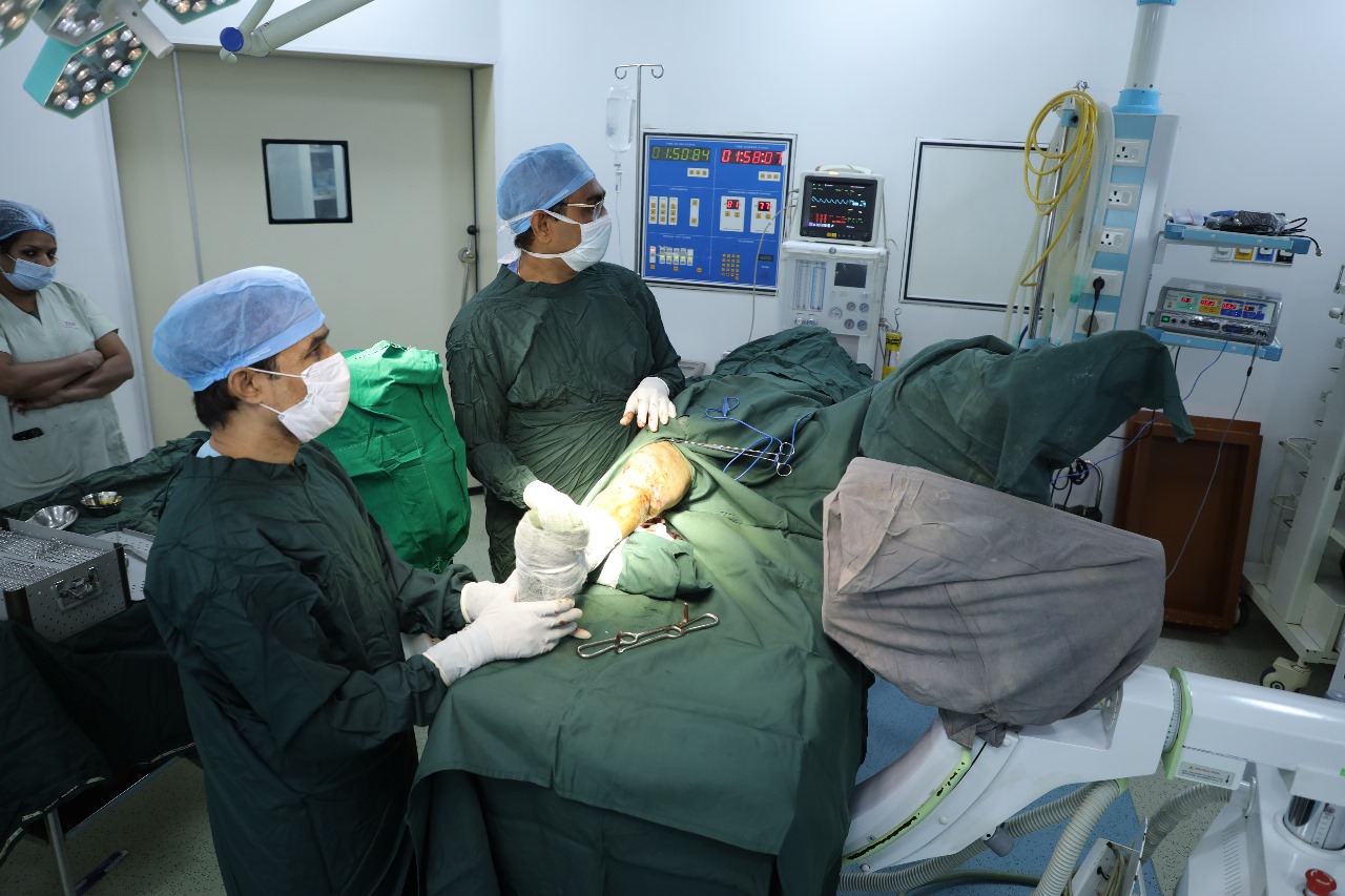 Dr. Girish Gupta consulting with patient at RK Hospital Indore